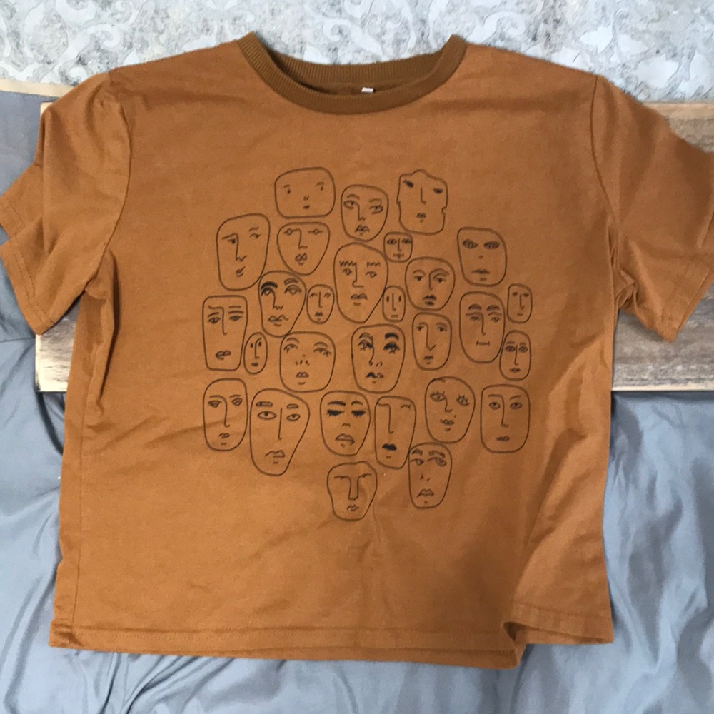 Size medium crop top from Amazon the shirt with many faces.